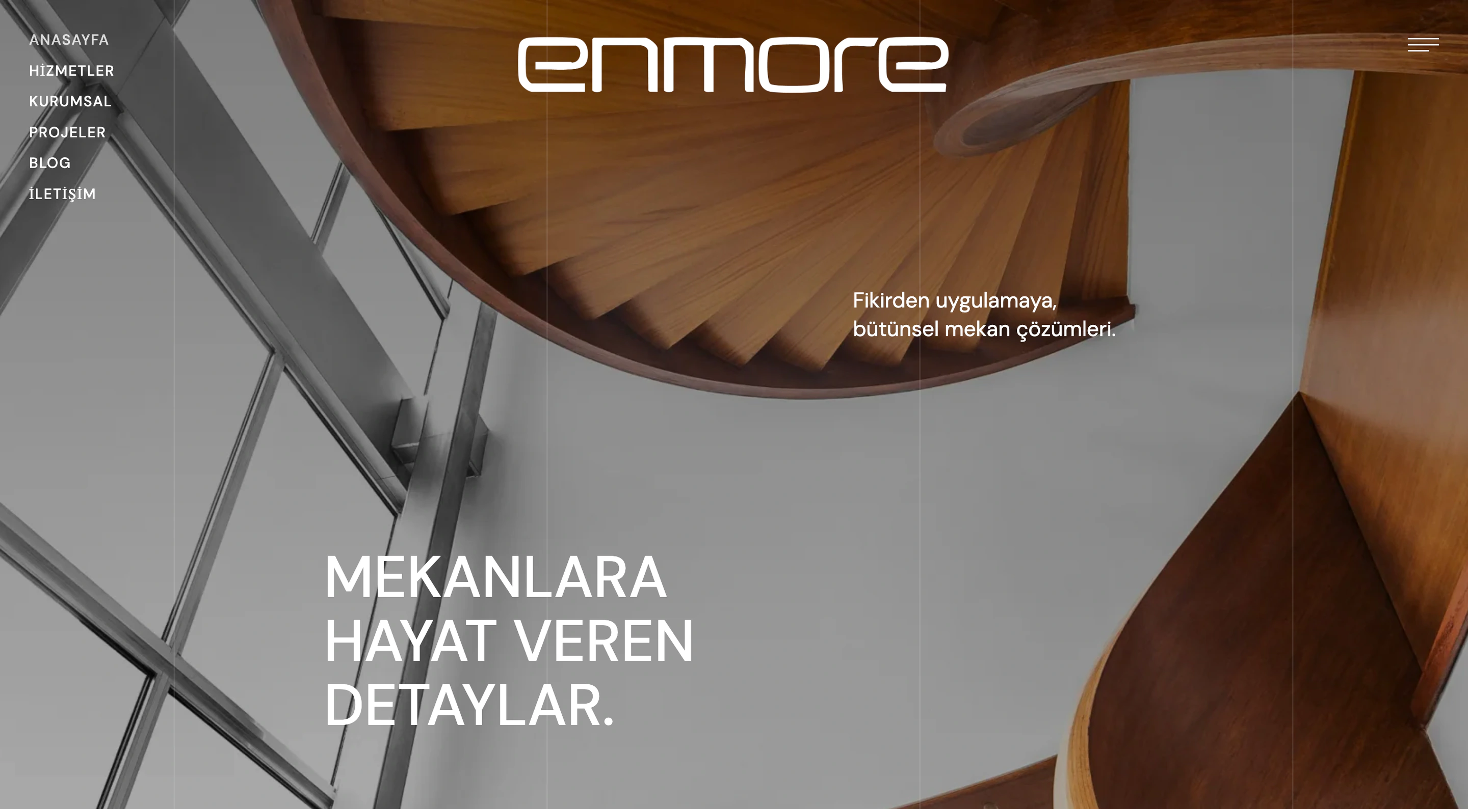 Enmore Group homepage with a white wordmark over an architectural spiral staircase photograph